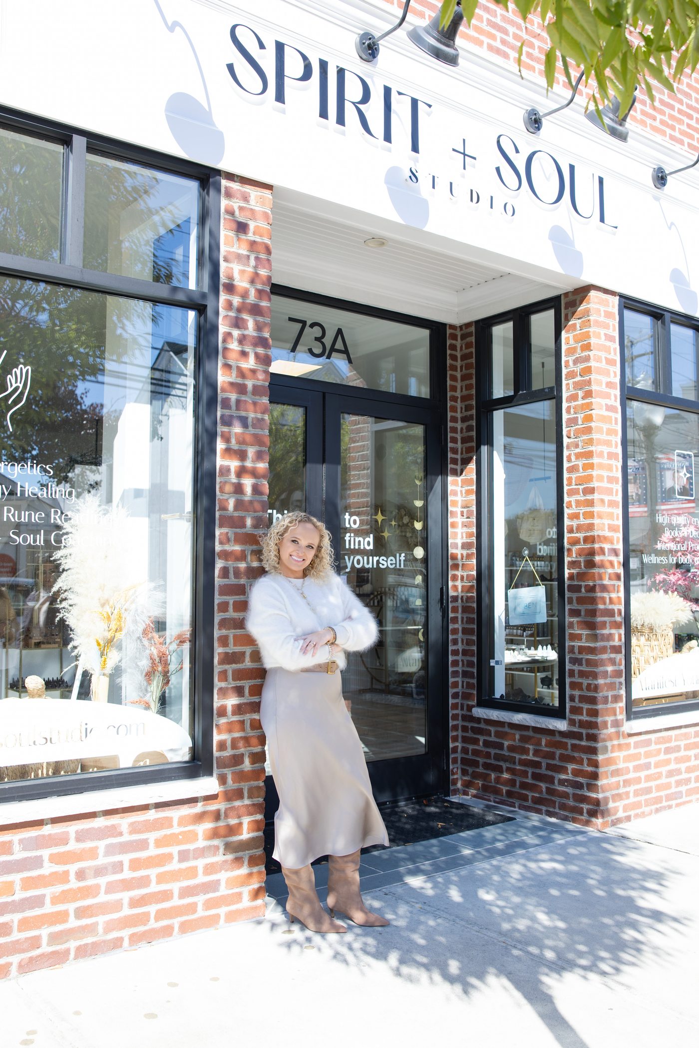 Tiffany standing outside the Spirit + Soul Studio storefront